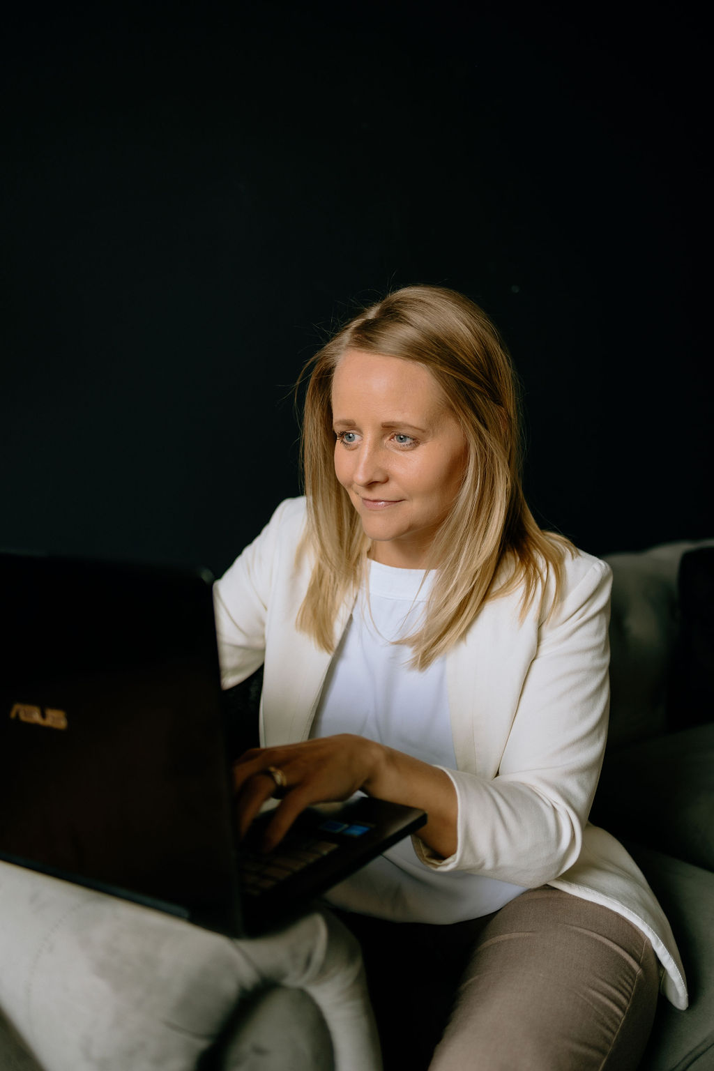 Toni Schafer focused on her laptop, working — entrepreneur and business builder